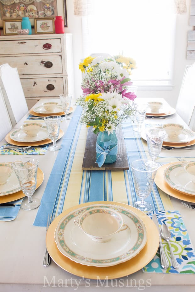 Add a few fresh flowers and bright table linens to vintage china and crystal and set a lovely blue and yellow spring tablescape for Easter or everyday.
