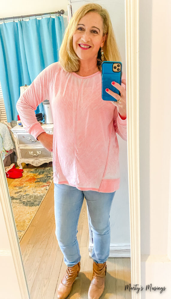 Woman in pink shirt with jeans in bedroom