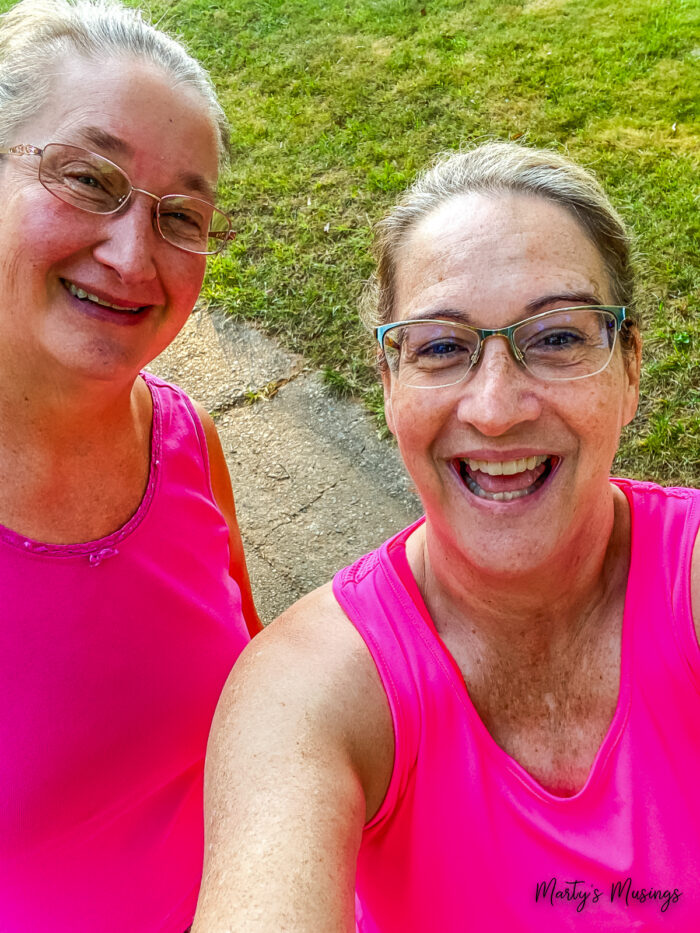 Two women in bright pink shirts