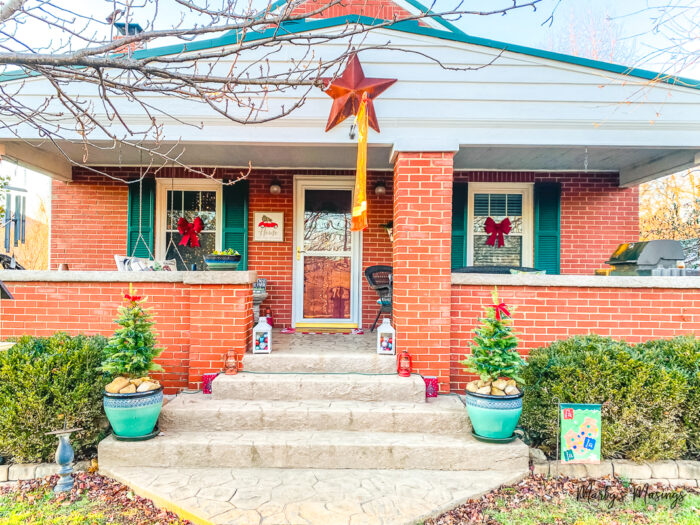 Craftsman style home decorated for Christmas in red and green colors