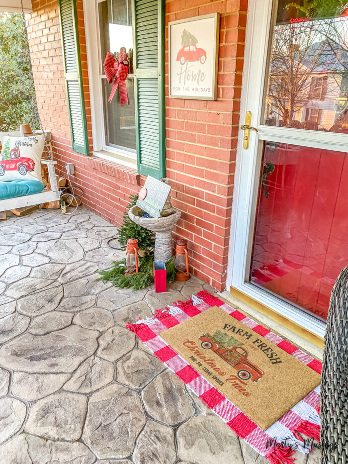 Craftsman front porch decorated for Christmas with red buffalo plaid