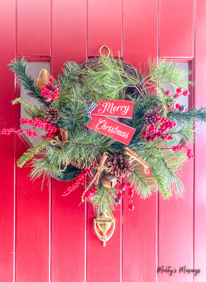 Merry Christmas wreath with red berries and pinecones