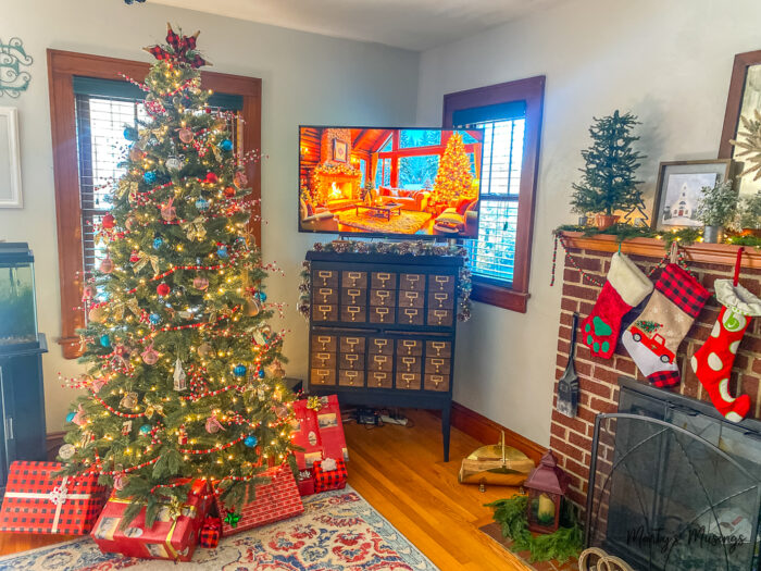 Christmas tree with red and blue decorations in living room