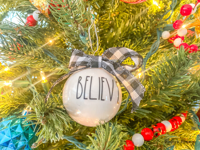 White believe ornament on Christmas tree