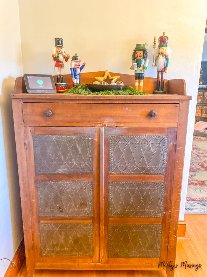 Antique pie safe with nutrcrackers on top for Christmas